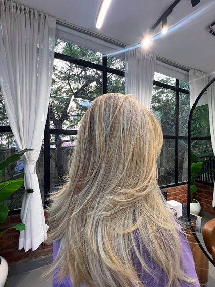 The final result of a complex color correction. The hair is now a beautiful, multi-dimensional blonde with healthy-looking layers.