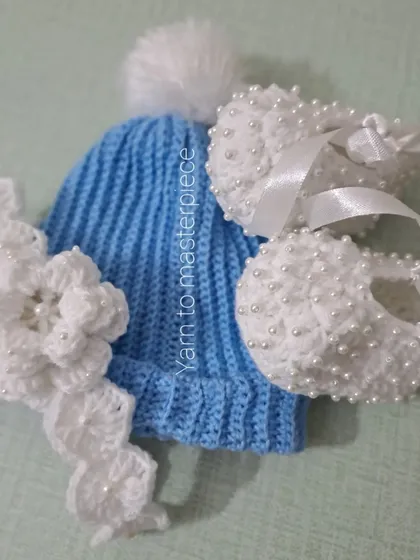 This custom set for a baby boy's baptism includes a cozy blue pom-pom beanie paired with my classic white pearl booties and a floral headband for his sibling.