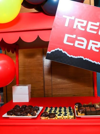 Even the food stations match the theme, like this red "Treat Cart" filled with delicious desserts for the Deadpool party.