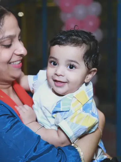 A candid shot of a mother holding her baby boy, both of them smiling. It’s these simple, joyful moments that make the most precious family memories.