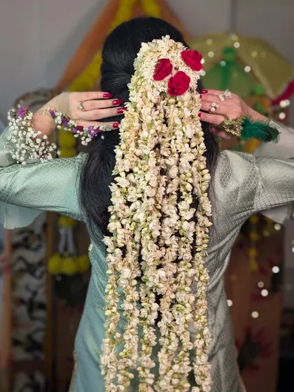 The full view of the magnificent floral hairstyle. This kind of dramatic and beautiful hair accessory makes a huge statement and looks incredible in photos.