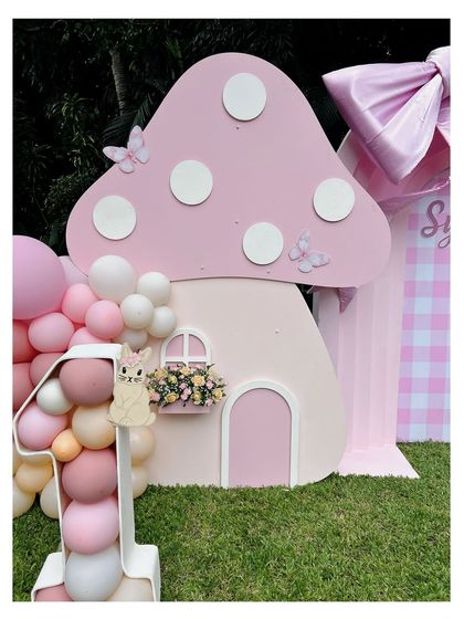 A close-up of the adorable mushroom house prop from our 'Bow & Bunny' theme. The polka-dot roof and tiny window box add to its whimsical charm.