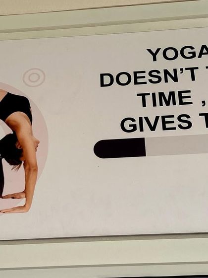 Our motto, displayed prominently in the studio: "Yoga doesn't take time, it gives time." This is the core belief that guides our practice and our teaching.