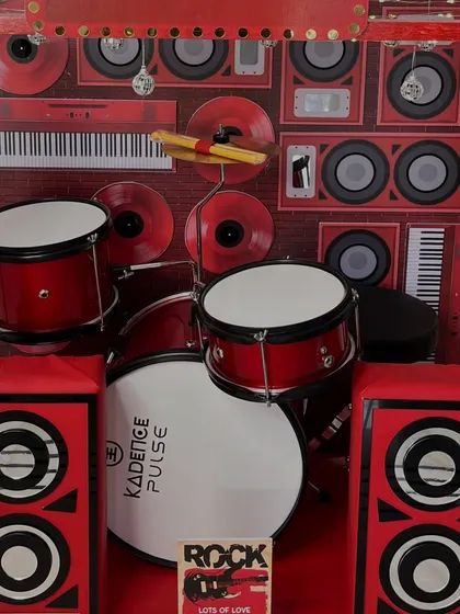 The centerpiece of the garage band is this amazing miniature drum kit, complete with a bass drum, cymbals, and drumsticks.