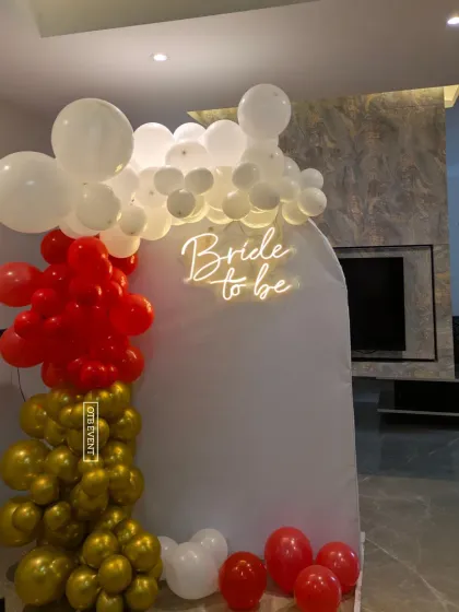 Another view of the red, white, and gold bridal shower decor, showing how it can transform a simple corner of a room.