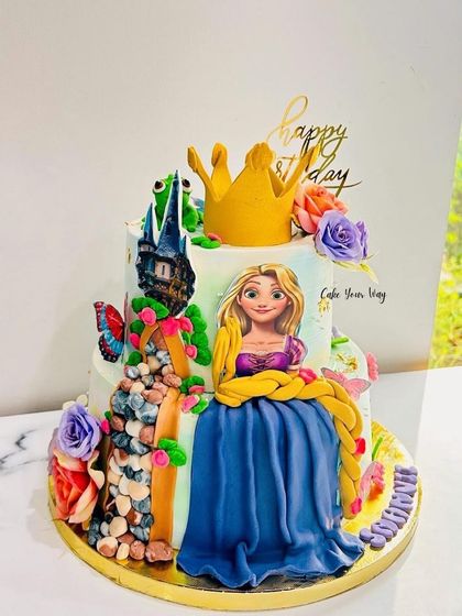 A magical Rapunzel cake, complete with her tower, long braided hair, and a royal crown.