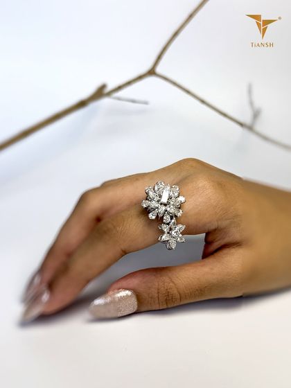 Delicate as a bloom, dazzling as a diamond. This floral statement ring, with its two distinct diamond flowers, is designed to make every gesture unforgettable.