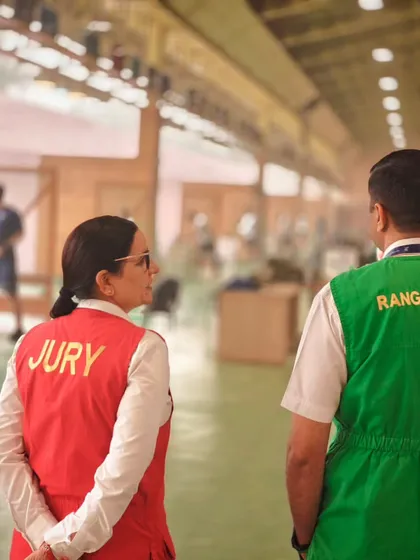 A Jury member and a Range Officer collaborate to oversee the competition. This partnership is crucial for the integrity of the sport, a principle we champion in our event management services.