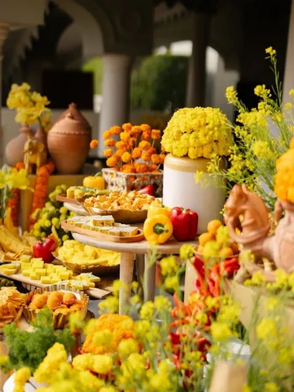 A vibrant food table at a Haldi ceremony, where the colors of the food and flowers are artfully combined. I believe that even the culinary presentation should be a feast for the eyes.