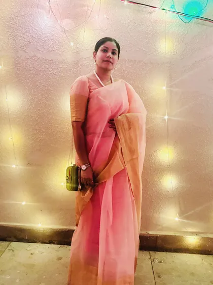 A lovely evening shot in my Durga Puja saree, with fairy lights creating a warm, magical glow.