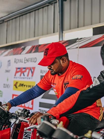 A coach helping a student get the feel of the bike. This hands-on approach builds confidence from the very start.