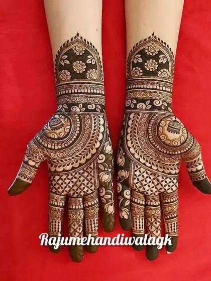 A classic design with a large central mandala and intricate patterns filling the rest of the hand. The dark, bold lines make the design stand out.
