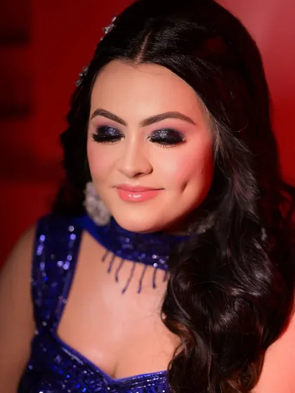A close-up of this stunning blue glitter smokey eye. This look is perfect for a cocktail party or reception, designed to catch the light and make your eyes the center of attention while keeping the skin fresh and glowing.