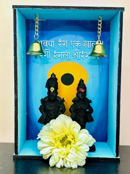 For Ashadhi Ekadashi, I created this wooden 'mandir' decor with a Vitthal theme. The piece features idols of Vitthal and Rukmini, with a hand-painted background and tiny bells.
