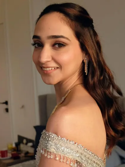 Different angles of this romantic half-up, half-down hairstyle. The soft waves and simple twist at the crown create a look that is both modern and timeless.