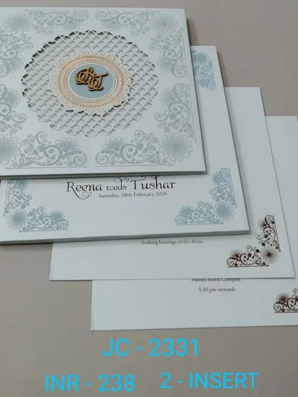 A modern invitation with a clean layout and a central monogram featuring a custom initial. The design is simple, stylish, and comes with two inserts.