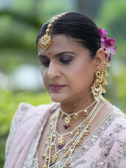 With eyes looking down, you can see the detail of the soft purple eyeshadow. I use colors that complement the client's outfit and skin tone.