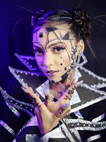 A close-up of the geometric avant-garde makeup, showing the use of dots, lines, and shapes to create a visually complex and stunning look.