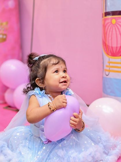 A sweet, upward glance from the birthday girl. Capturing these fleeting expressions is key to authentic kids' birthday photography, preserving the innocence and wonder of childhood.