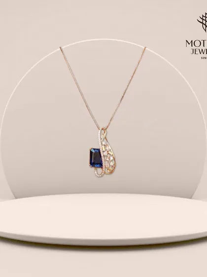 A graceful pendant featuring a deep blue sapphire in a swirling diamond setting. The elegant design and rich color make this a sophisticated piece for any jewellery lover.