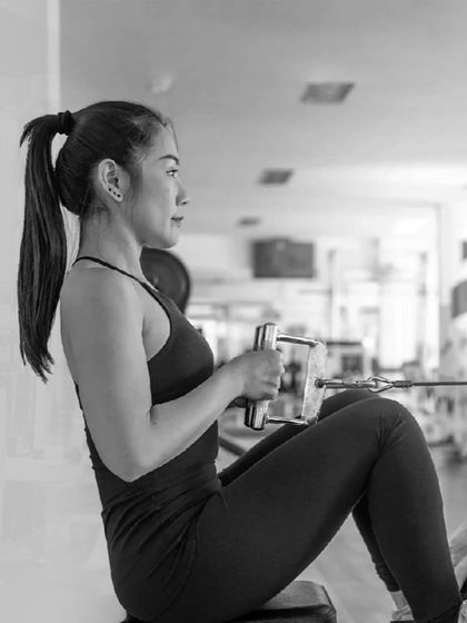 No shortcuts, just hard work. A member focuses on her seated cable row, a key exercise for developing back thickness and strength.