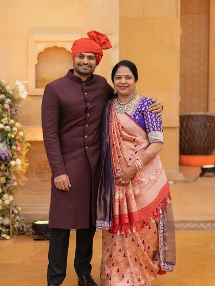 A portrait of the brother of the bride with his mother. We styled him in a rich maroon sherwani that complements his mother's beautiful saree, creating an elegant family look.