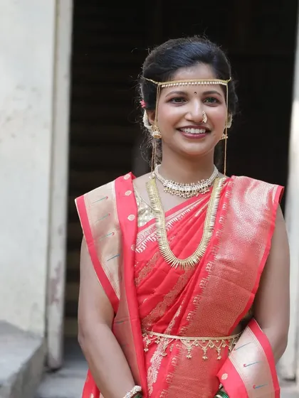 My happy bride Sanchita, looking radiant in a red saree for her wedding ceremony. Her natural smile says it all. The makeup is kept minimal to highlight her joy.