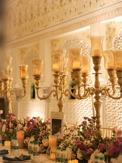 The tables were adorned with tall candelabras and lush floral arrangements. We used personalized place cards with the couple's photos, a small detail that the groom was very particular about to ensure a great guest experience.