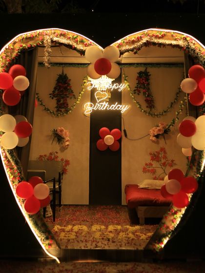 A birthday surprise waiting to happen. This heart-shaped cabana is decorated with a "Happy Birthday" neon sign and balloons, creating a private and festive space for your celebration.