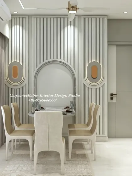 A compact dining nook with a round table and elegant chairs. The wall is adorned with fluted panels and modern sconces, creating a cozy and stylish corner.