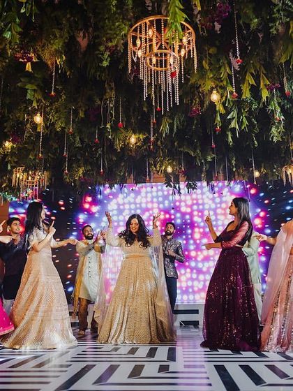 A collage of moments from the #GJinLove sangeet, showcasing various group performances from friends and family, all full of energy and smiles.