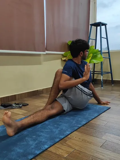 This is Matsyendrasana, a seated spinal twist that helps to increase the elasticity of the spine and tone the spinal nerves. It's also beneficial for managing conditions like fatty liver.