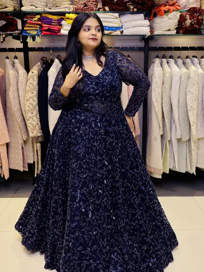 This image highlights the power and drama of our navy blue gown, a perfect rental for making a statement.