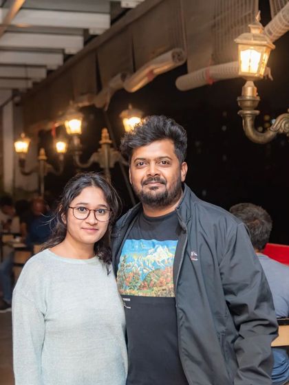 A couple posing for a photo on the rooftop.