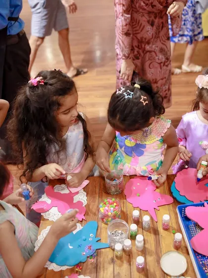 A group of children works together on a unicorn craft project. Our guided activities are a great way for kids to be creative and make their own party favor.