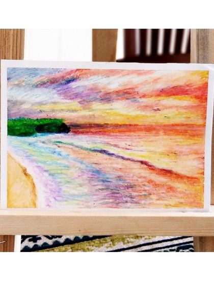 A soft, colorful beach scene rendered in oil pastels, demonstrating how this medium can be used to create gentle, blended effects.