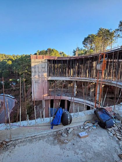 A view from one of the upper levels of the construction site, looking out over the curved balcony. This shot captures the feeling of being perched among the treetops, a key experience the final design will offer.