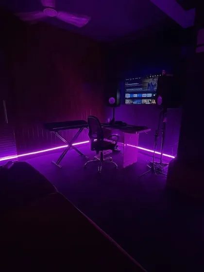 We believe the right atmosphere inspires great music. Our studio features adjustable mood lighting, like this vibrant purple glow, to help you create the perfect vibe for your creative session, whether you're recording, writing, or just jamming.