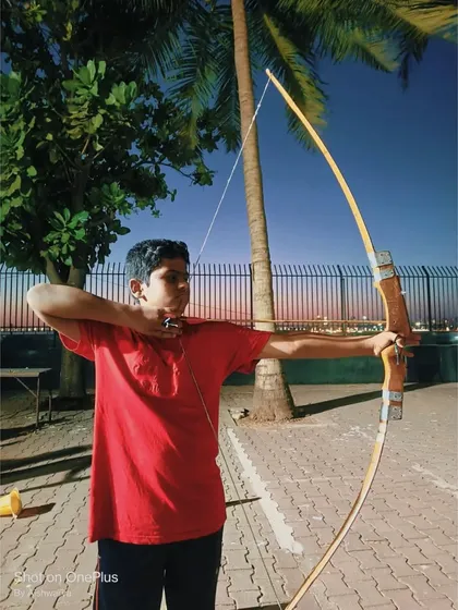 This young man is concentrating hard, a key skill that archery helps to develop.