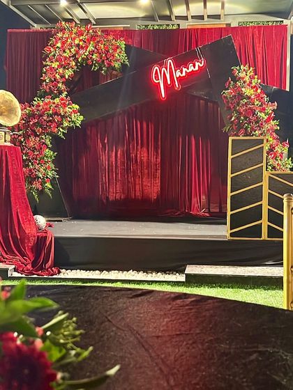 A retro-glam musical night stage. We used red velvet curtains, a custom neon sign, and a vintage gramophone prop to create a unique and stylish setting for an evening of music.