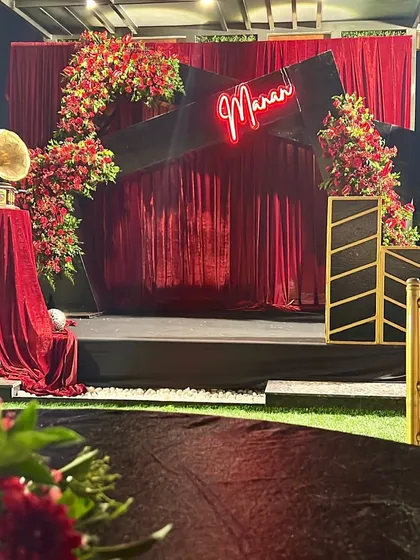 A retro-glam musical night stage. We used red velvet curtains, a custom neon sign, and a vintage gramophone prop to create a unique and stylish setting for an evening of music.