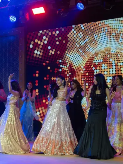 The bride and her bridesmaids in a beautifully coordinated dance. The glittering stage and lighting are designed to make everyone feel like a star.