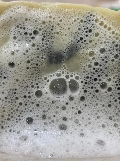 The rich, bubbly lather of our Charcoal & Dead Sea Mud Soap. It provides a deep cleanse without stripping your skin of its natural moisture.