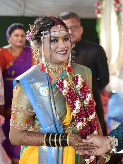 A candid moment between the bride and groom. Her makeup is flawless, ensuring she looks her best as she begins her new life.