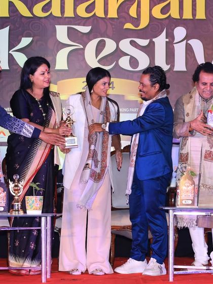 Being felicitated on stage at the Kalanajali Folk Festival. It is an honor to be recognized for my work in the field of dance.