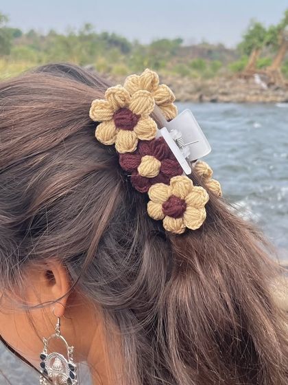 Another angle of the floral claw clip, highlighting the texture and detail of the crochet flowers.