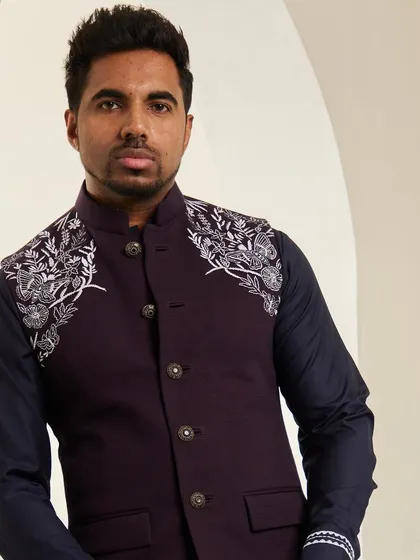 A close-up portrait showcasing the intricate silver embroidery on the shoulder of the space blue bundi. This detail is designed to draw the eye and signify quality.