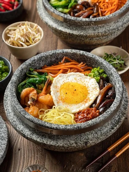 A close-up of the shrimp and egg hot pot from YouMee, highlighting the perfectly fried egg.