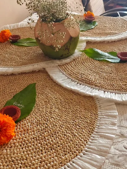Elegant woven mats and personalized name cards on leaves for a Diwali supper club. These small touches help create a warm and memorable festive atmosphere.