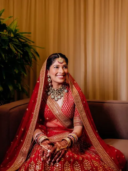 Sonali was a picture of regal grace for her wedding ceremony. I created a classic bridal look with defined eyes and a warm glow that perfectly complemented her traditional red Sabyasachi lehenga.